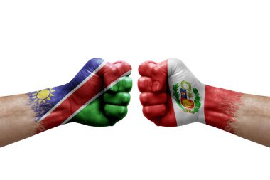 Two hands punch to each others on white background. Country flags painted fists, conflict crisis concept between namibia and peru