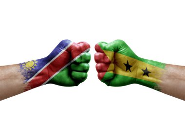 Two hands punch to each others on white background. Country flags painted fists, conflict crisis concept between namibia and sao tome and principe
