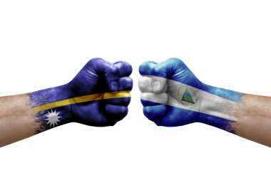 Two hands punch to each others on white background. Country flags painted fists, conflict crisis concept between nauru and nicaragua