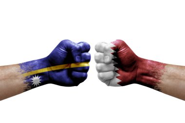 Two hands punch to each others on white background. Country flags painted fists, conflict crisis concept between nauru and qatar