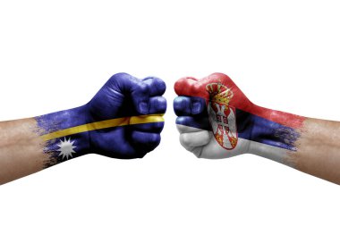 Two hands punch to each others on white background. Country flags painted fists, conflict crisis concept between nauru and serbia