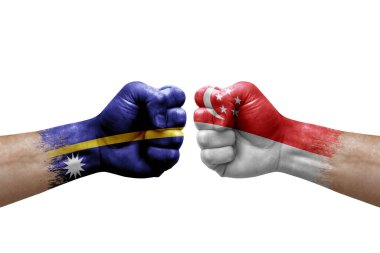 Two hands punch to each others on white background. Country flags painted fists, conflict crisis concept between nauru and singapore