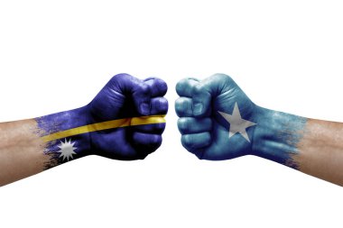 Two hands punch to each others on white background. Country flags painted fists, conflict crisis concept between nauru and somalia