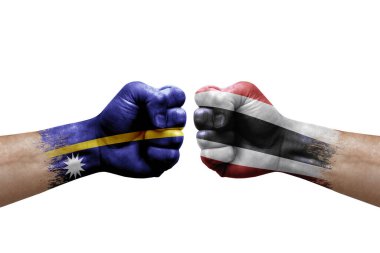 Two hands punch to each others on white background. Country flags painted fists, conflict crisis concept between nauru and thailand