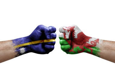 Two hands punch to each others on white background. Country flags painted fists, conflict crisis concept between nauru and wales