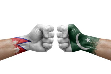 Two hands punch to each others on white background. Country flags painted fists, conflict crisis concept between nepal and pakistan