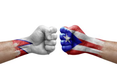 Two hands punch to each others on white background. Country flags painted fists, conflict crisis concept between nepal and puerto rico