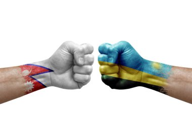 Two hands punch to each others on white background. Country flags painted fists, conflict crisis concept between nepal and rwanda