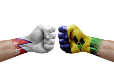 Two hands punch to each others on white background. Country flags painted fists, conflict crisis concept between nepal and saint vincent and the grenadines