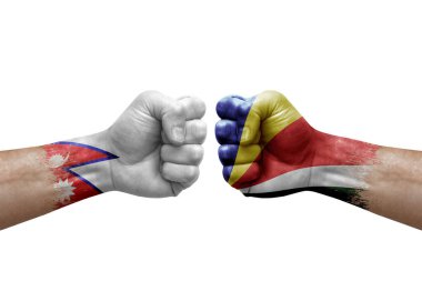 Two hands punch to each others on white background. Country flags painted fists, conflict crisis concept between nepal and seychelles