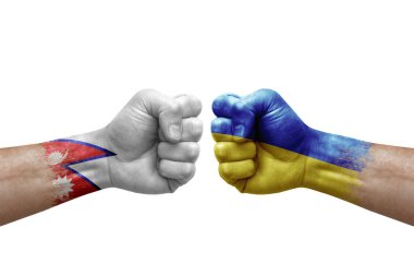 Two hands punch to each others on white background. Country flags painted fists, conflict crisis concept between nepal and ukraine