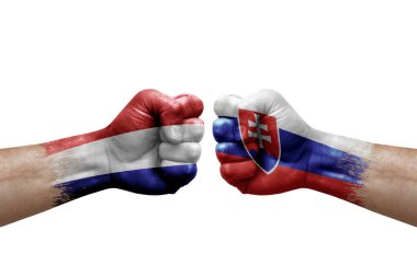 Two hands punch to each others on white background. Country flags painted fists, conflict crisis concept between netherlands and slovakia