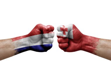 Two hands punch to each others on white background. Country flags painted fists, conflict crisis concept between netherlands and tonga