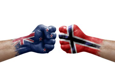 Two hands punch to each others on white background. Country flags painted fists, conflict crisis concept between new zealand and norway