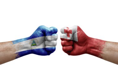 Two hands punch to each others on white background. Country flags painted fists, conflict crisis concept between nicaragua and tonga
