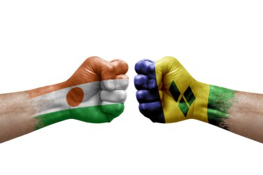 Two hands punch to each others on white background. Country flags painted fists, conflict crisis concept between niger and saint vincent and the grenadines