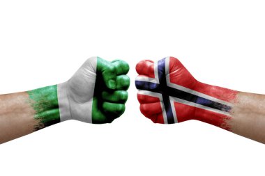 Two hands punch to each others on white background. Country flags painted fists, conflict crisis concept between nigeria and norway