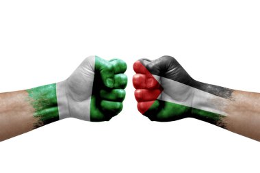 Two hands punch to each others on white background. Country flags painted fists, conflict crisis concept between nigeria and palestine