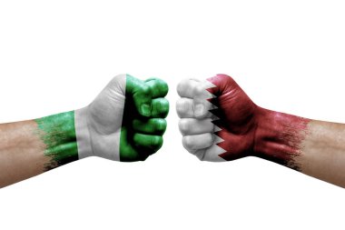 Two hands punch to each others on white background. Country flags painted fists, conflict crisis concept between nigeria and qatar