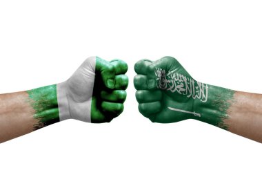 Two hands punch to each others on white background. Country flags painted fists, conflict crisis concept between nigeria and saudi arabia
