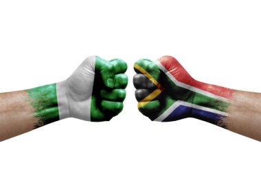Two hands punch to each others on white background. Country flags painted fists, conflict crisis concept between nigeria and south africa