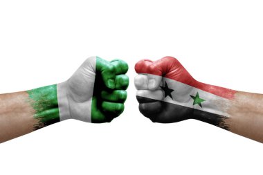Two hands punch to each others on white background. Country flags painted fists, conflict crisis concept between nigeria and syria