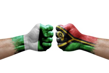 Two hands punch to each others on white background. Country flags painted fists, conflict crisis concept between nigeria and vanuatu