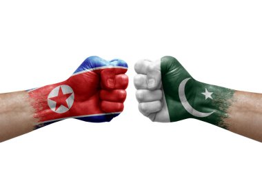 Two hands punch to each others on white background. Country flags painted fists, conflict crisis concept between north korea and pakistan