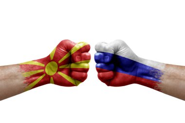 Two hands punch to each others on white background. Country flags painted fists, conflict crisis concept between north macedonia and russia