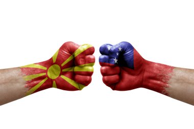 Two hands punch to each others on white background. Country flags painted fists, conflict crisis concept between north macedonia and samoa