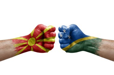 Two hands punch to each others on white background. Country flags painted fists, conflict crisis concept between north macedonia and solomon islands