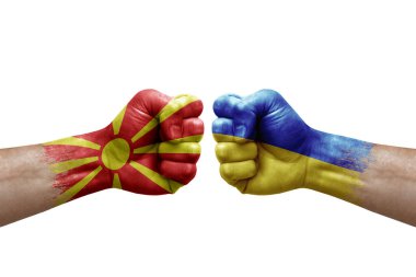 Two hands punch to each others on white background. Country flags painted fists, conflict crisis concept between north macedonia and ukraine