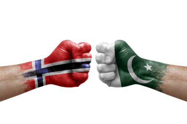 Two hands punch to each others on white background. Country flags painted fists, conflict crisis concept between norway and pakistan