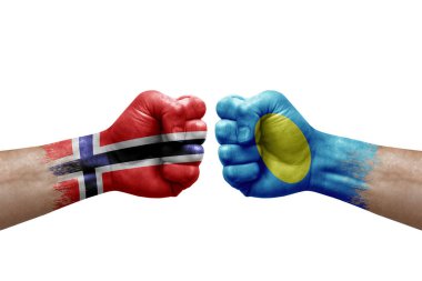 Two hands punch to each others on white background. Country flags painted fists, conflict crisis concept between norway and palau