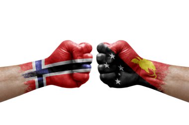 Two hands punch to each others on white background. Country flags painted fists, conflict crisis concept between norway and papua new guinea