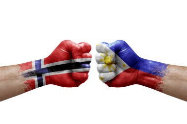 Two hands punch to each others on white background. Country flags painted fists, conflict crisis concept between norway and philippines
