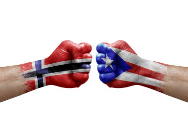 Two hands punch to each others on white background. Country flags painted fists, conflict crisis concept between norway and puerto rico