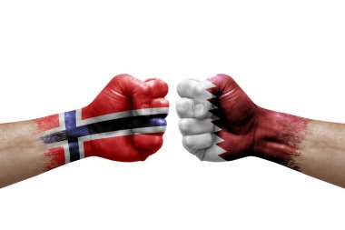 Two hands punch to each others on white background. Country flags painted fists, conflict crisis concept between norway and qatar
