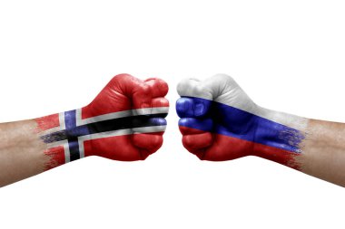 Two hands punch to each others on white background. Country flags painted fists, conflict crisis concept between norway and russia