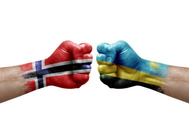 Two hands punch to each others on white background. Country flags painted fists, conflict crisis concept between norway and rwanda