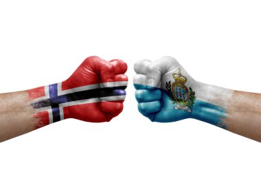 Two hands punch to each others on white background. Country flags painted fists, conflict crisis concept between norway and san marino