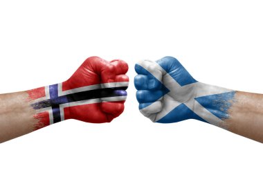 Two hands punch to each others on white background. Country flags painted fists, conflict crisis concept between norway and scotland