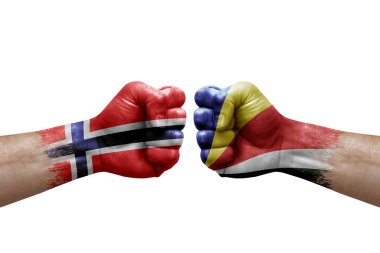 Two hands punch to each others on white background. Country flags painted fists, conflict crisis concept between norway and seychelles