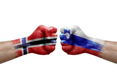 Two hands punch to each others on white background. Country flags painted fists, conflict crisis concept between norway and slovenia