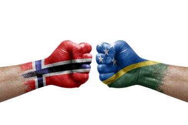 Two hands punch to each others on white background. Country flags painted fists, conflict crisis concept between norway and solomon islands