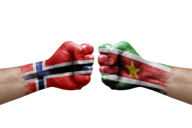 Two hands punch to each others on white background. Country flags painted fists, conflict crisis concept between norway and suriname