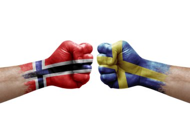 Two hands punch to each others on white background. Country flags painted fists, conflict crisis concept between norway and sweden