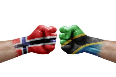 Two hands punch to each others on white background. Country flags painted fists, conflict crisis concept between norway and tanzania