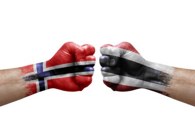 Two hands punch to each others on white background. Country flags painted fists, conflict crisis concept between norway and thailand