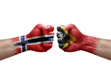 Two hands punch to each others on white background. Country flags painted fists, conflict crisis concept between norway and timor leste